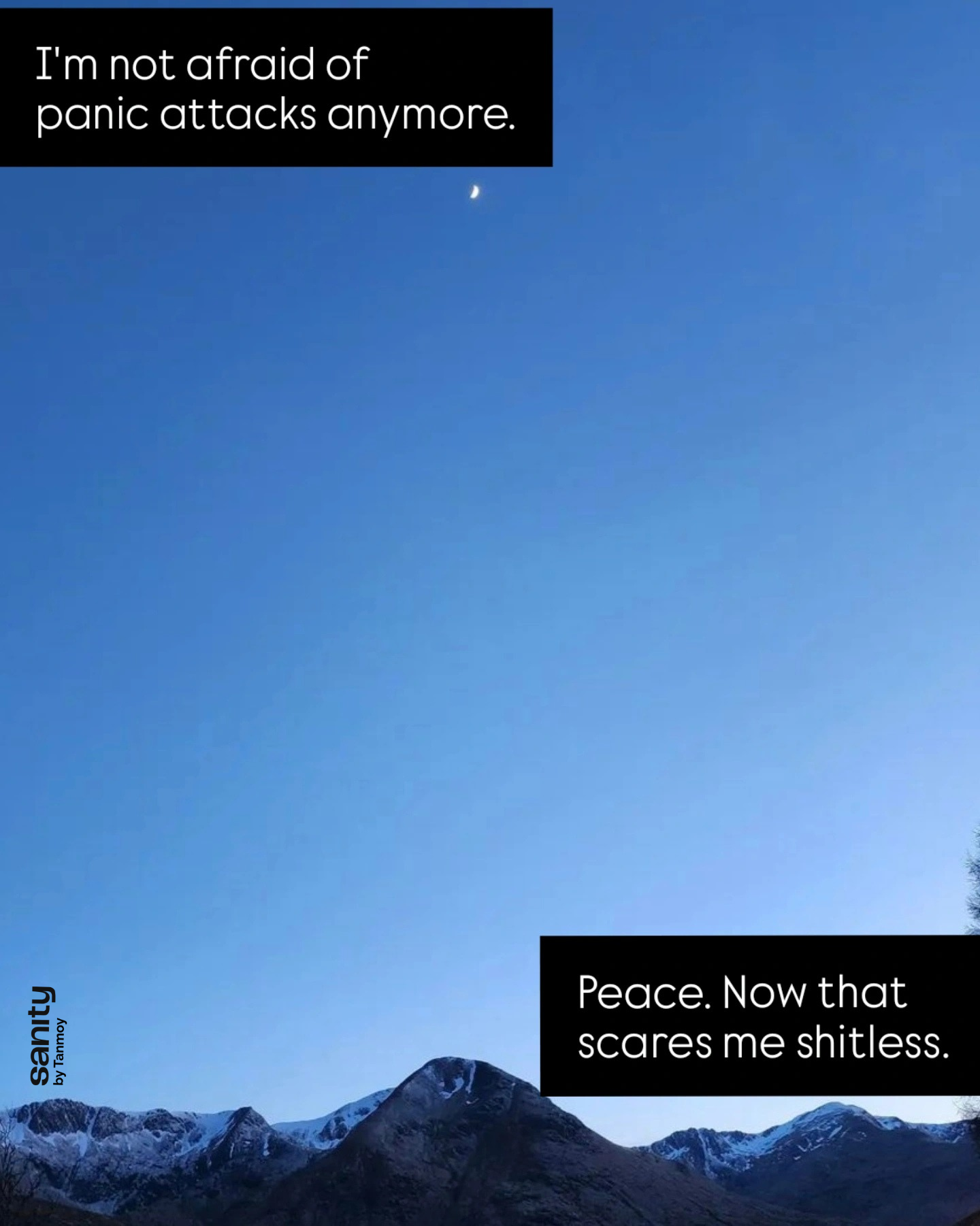 A photo of a vast blue sky. At the top is a crescent moon. At the bottom is a mountain range. The text reads: "I am not afraid of panic attacks anymore. Peace. Now that scares me shitless."